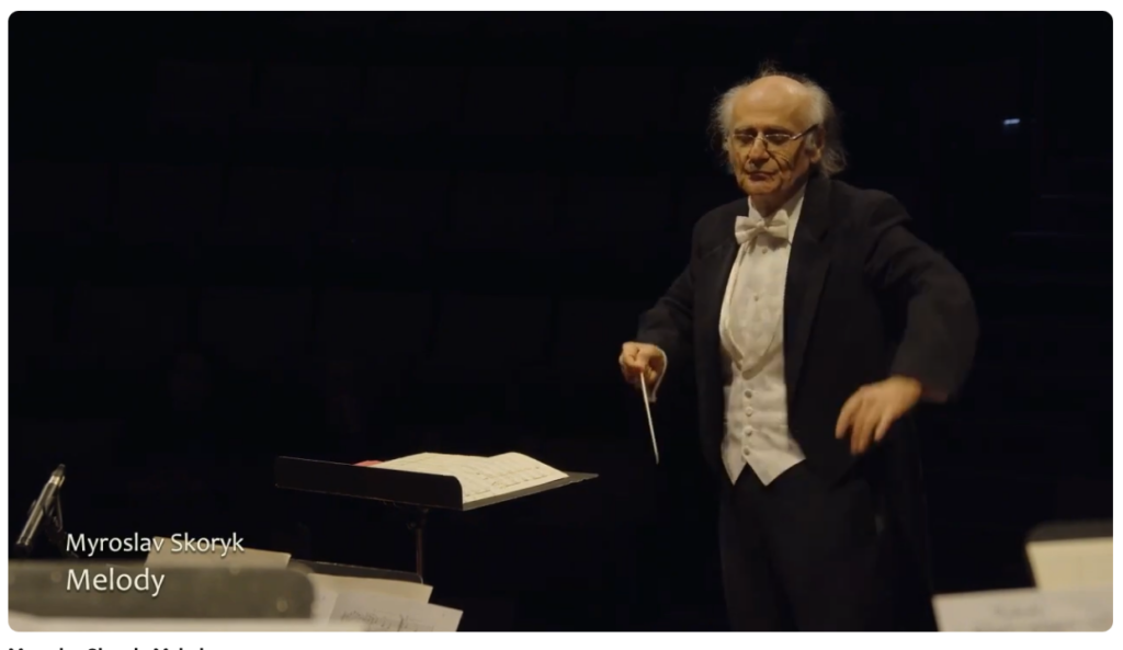 In the heart of Kyiv, an extraordinary musical event unfolded in near darkness during a blackout. Outside the historic Architect's House, a symphony orchestra from Mariupol performed the deeply moving piece “Melody” by renowned Ukrainian composer Mykhailo Skoryk.